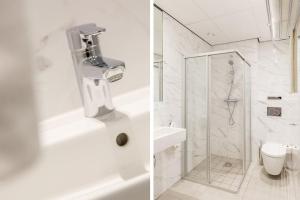 a white bathroom with a shower and a toilet at Hotel2Stay in Amsterdam +53 photos