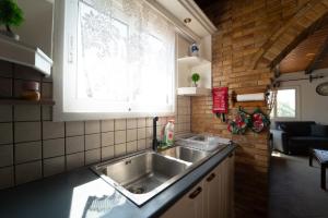 a kitchen with a sink and a window at Popolaros Traditional House in Zakynthos +23 photos