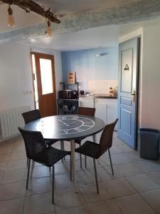 eine Küche mit Tisch und Stühlen in einem Zimmer in der Unterkunft Entre Terre et Mer La Bichette in Guisy