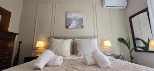 a bedroom with a bed with white pillows at Casa de las Olas in Torremolinos