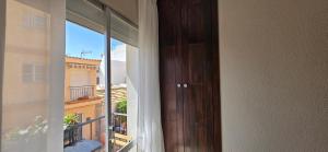 eine Tür zu einem Balkon mit Blick auf ein Gebäude in der Unterkunft Casa de las Olas in Torremolinos