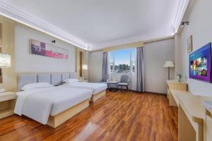 Postel nebo postele na pokoji v ubytování Galaxy Hotel Guangzhou + 250 fotografií