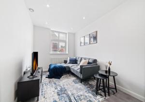 a living room with a couch and a table at The Sapphire Suite - 2BR 2Bath City Centre in Leicester