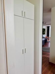 a white closet with white cabinets in a living room at Strandstudio 19, Exklusive Wohnung, erste Reihe, Strand, Kamin in Binz +29 photos