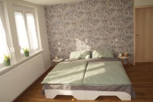 a bedroom with a bed with a floral accent wall at Ferienwohnung Schelklewiese in Baiersbronn