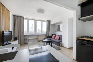 a living room with a couch and a table at Apartament Centrum in Warsaw