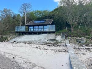a house on top of a hill with a beach at Loff Holiday Houses in Aabenraa
