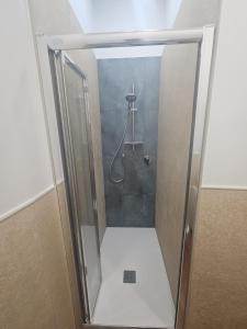 a shower with a glass door in a bathroom at La Via del Mare in Giardini Naxos