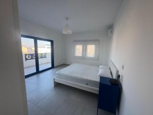 a white bedroom with a bed and a window at Marassi El Alamein Luxury Villa مراسي العلمين in El Alamein +21 photos