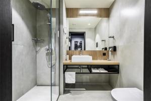 a bathroom with a shower and a sink at Park Inn by Radisson Vilnius Airport Hotel & Conference Centre in Vilnius