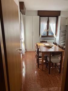 a kitchen and dining room with a table and chairs at Poma Luxury 1 Piano in Borno +13 photos