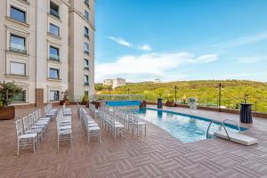 a hotel patio with chairs and a pool at Limak Eurasia Luxury Hotel in Istanbul