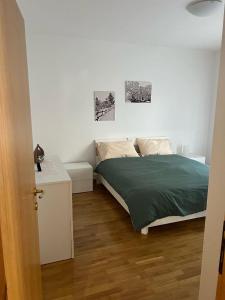 a bedroom with a bed with a green blanket at Poma Luxury 1 Piano in Borno