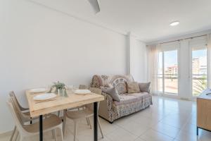 a living room with a table and a couch at Entre Castillo y Mar in Santa Pola