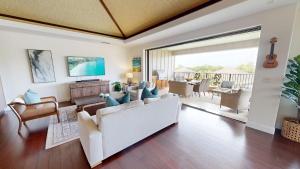 a living room with a white couch and chairs at ONCE UPON A TIDE Charming 4BR KaMilo Home with Bikes and Beach Gear in Waikoloa