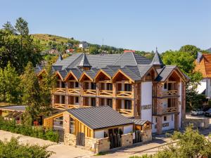 an image of a large house with a metal roof at Forest Green & Spa in Gura Humorului