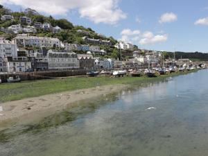 a body of water with a bunch of houses and boats at Barn Cottage in Liskeard