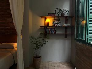 a bedroom with a bed and a potted plant at PREEZE boutique stay in Vung Tau