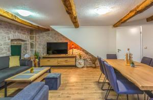 a living room with a table and a couch at MSV Modern Stone Villa in Imotski