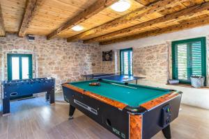 a large room with a pool table and somewindows at MSV Modern Stone Villa in Imotski +56 photos
