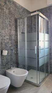 a bathroom with a glass shower and a sink at Onda Blu in Rimini +10 photos