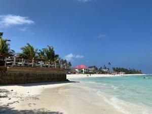 a beach with the ocean and a resort at Kipe House Nungwi in Nungwi