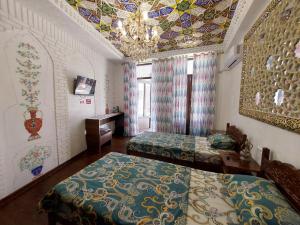 Кровать или кровати в номере Hotel Gulnaraxanum Boutique This hotel is nearby the center of the old city Every room decorated in the unique style