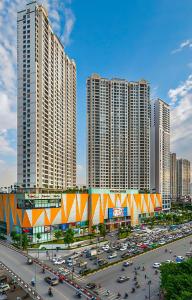 a city with tall buildings and a parking lot with cars at Tami Homes - Vinhomes D'Capitale Executive Apartment in Hanoi