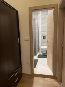 a bathroom with a door leading to a toilet at North Star - sea apartment in Balchik +20 photos