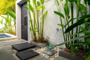 un ingresso dal giardino di una casa con piscina di Jineng Febe G Villa a Seminyak
