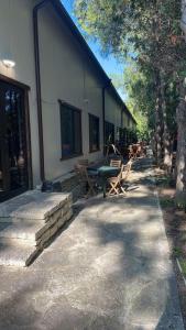a building with a picnic table and benches in front of it at North Star - sea apartment in Balchik