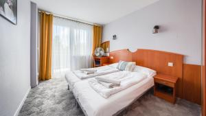 Posteľ alebo postele v izbe v ubytovaní Apartamenty Sun & Snow w Rezydencji Bielik
