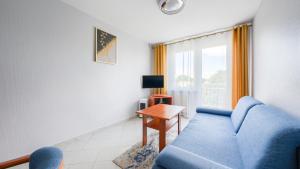 Televízia a/alebo spoločenská miestnosť v ubytovaní Apartamenty Sun & Snow w Rezydencji Bielik