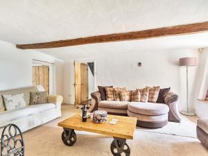 a living room with a couch and a coffee table at 2 Pigsfoot Cottages in Tiverton +47 photos