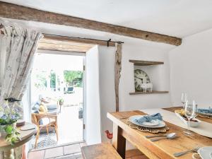 a kitchen with a table and a dining room at 2 Pigsfoot Cottages in Tiverton