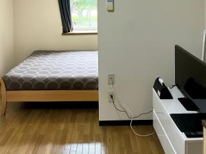 Postel nebo postele na pokoji v ubytování KIYAZA Oak Sapporo