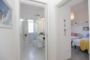 Un baño blanco con lavabo e inodoro. en FORTE DEI MARMI - 500m to the sea, en Marina di Massa 21 fotos más