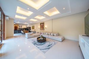 a living room with a couch and a table at Villa Ellyne Canggu by Nagisa Bali in Canggu +37 photos