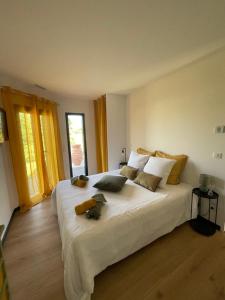 a bedroom with a large white bed with pillows at Villa 7 in Martillac +32 photos