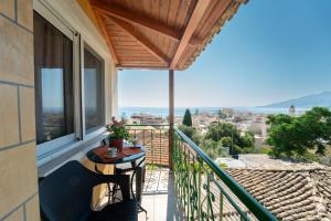 a balcony with a table and a view of a city at Popolaros Traditional House in Zakynthos