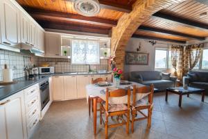 a kitchen and living room with a table and chairs at Popolaros Traditional House in Zakynthos