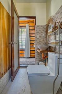 a bathroom with a toilet and a sink at Central Cozy Bungalow 2 with AC and WIFI 5 min to Beach in General Luna