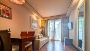 a living room with a table and a couch at Luxury Dreamland Oasis Apartments in Chakvi