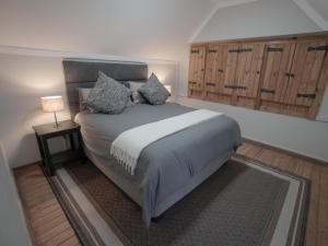 a bedroom with a bed and a lamp on a rug at Insolam Accommodation in Mokopane