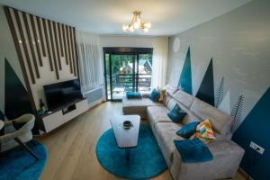 a living room with a couch and a television at Villa Jezero 4 in Žabljak
