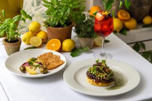 a table with two plates of food and a drink at Roslin Beach Hotel in Southend-on-Sea