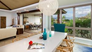 a kitchen and living room with a table and chairs at SLICE OF PARADISE Well-Appointed 4BR KaMilo Home with Private Beach Club in Waikoloa