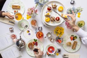 a white table with plates of food and people eating at Roslin Beach Hotel in Southend-on-Sea