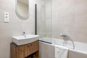 a bathroom with a sink and a bath tub at A60 Apartment Hotel in Budapest +202 photos