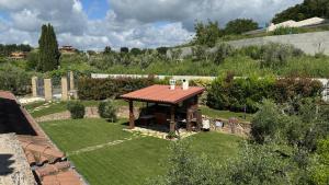 a small garden with a gazebo in the grass at Linda's Retreat B&B in Fiano Romano